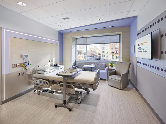 hospital room with bed, couch, chair and tv